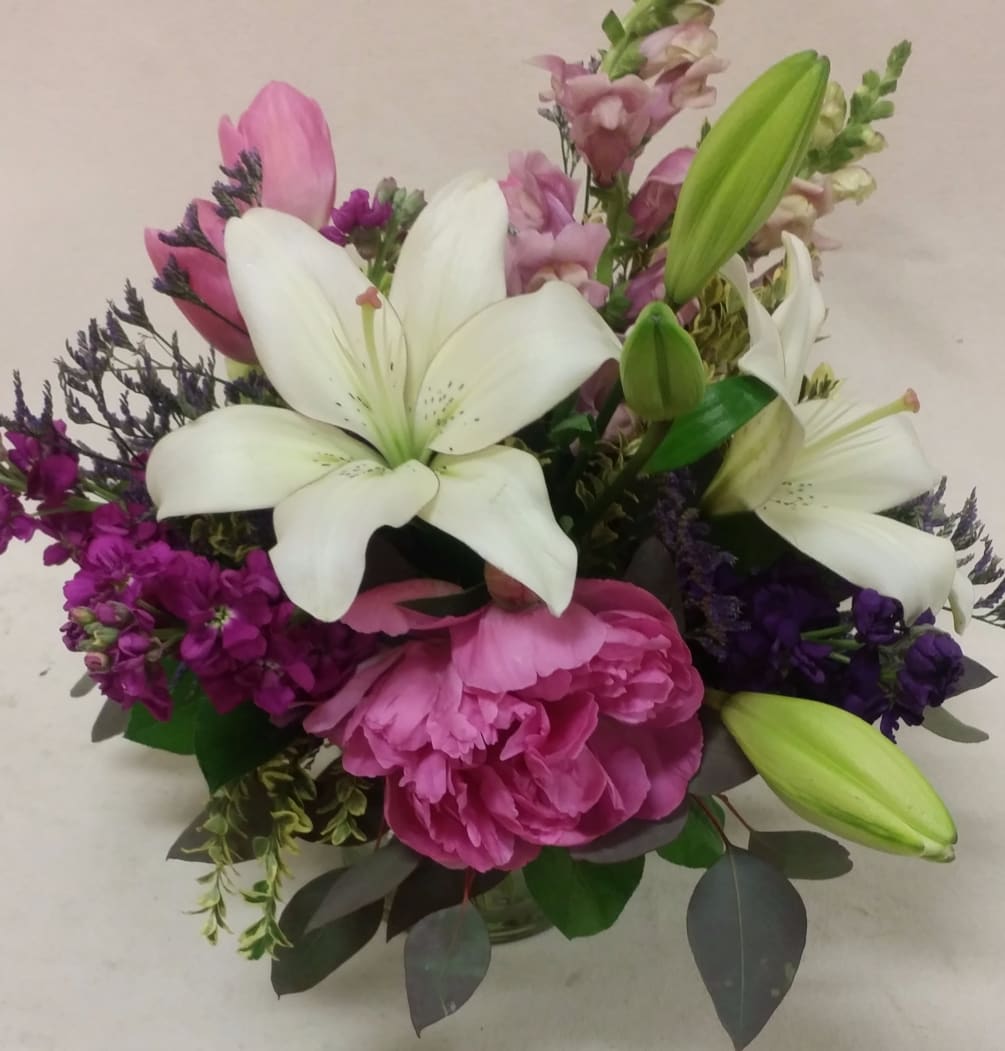 Purples, hot pink, and magenta blossoms are highlighted with a creamy Asiatic