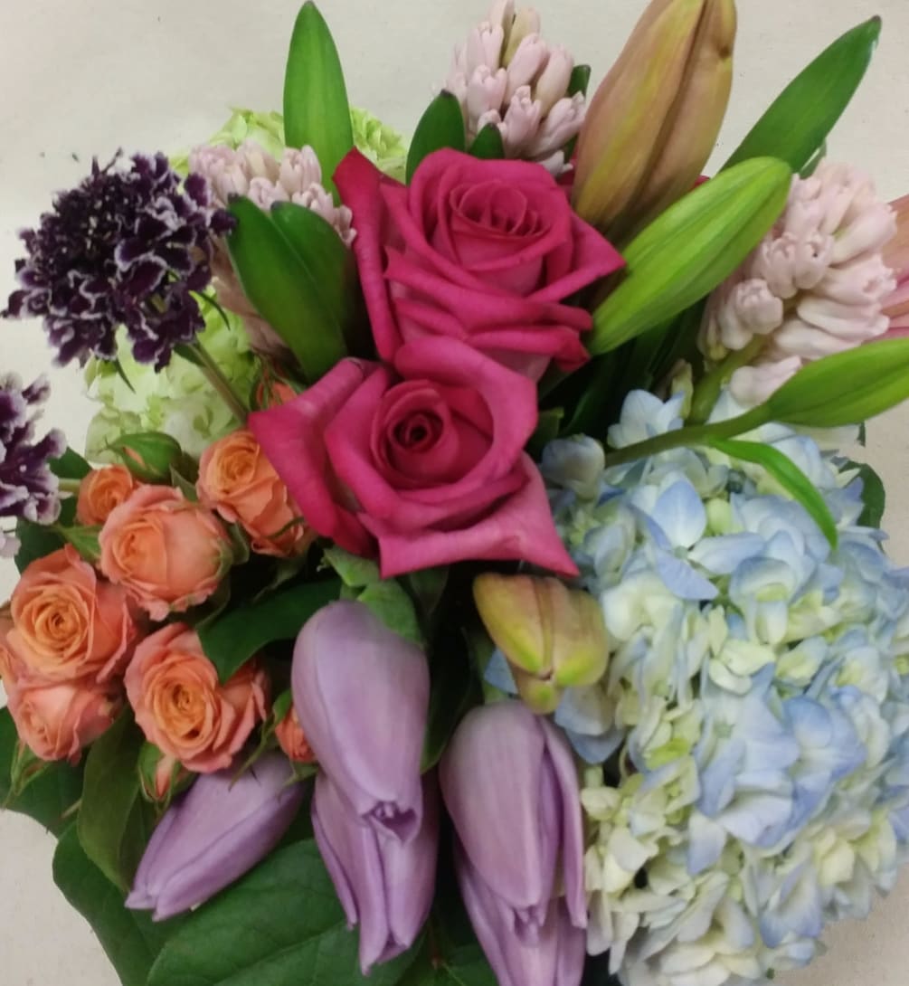 An interesting array of colorful premium blooms are arranged in almost musical