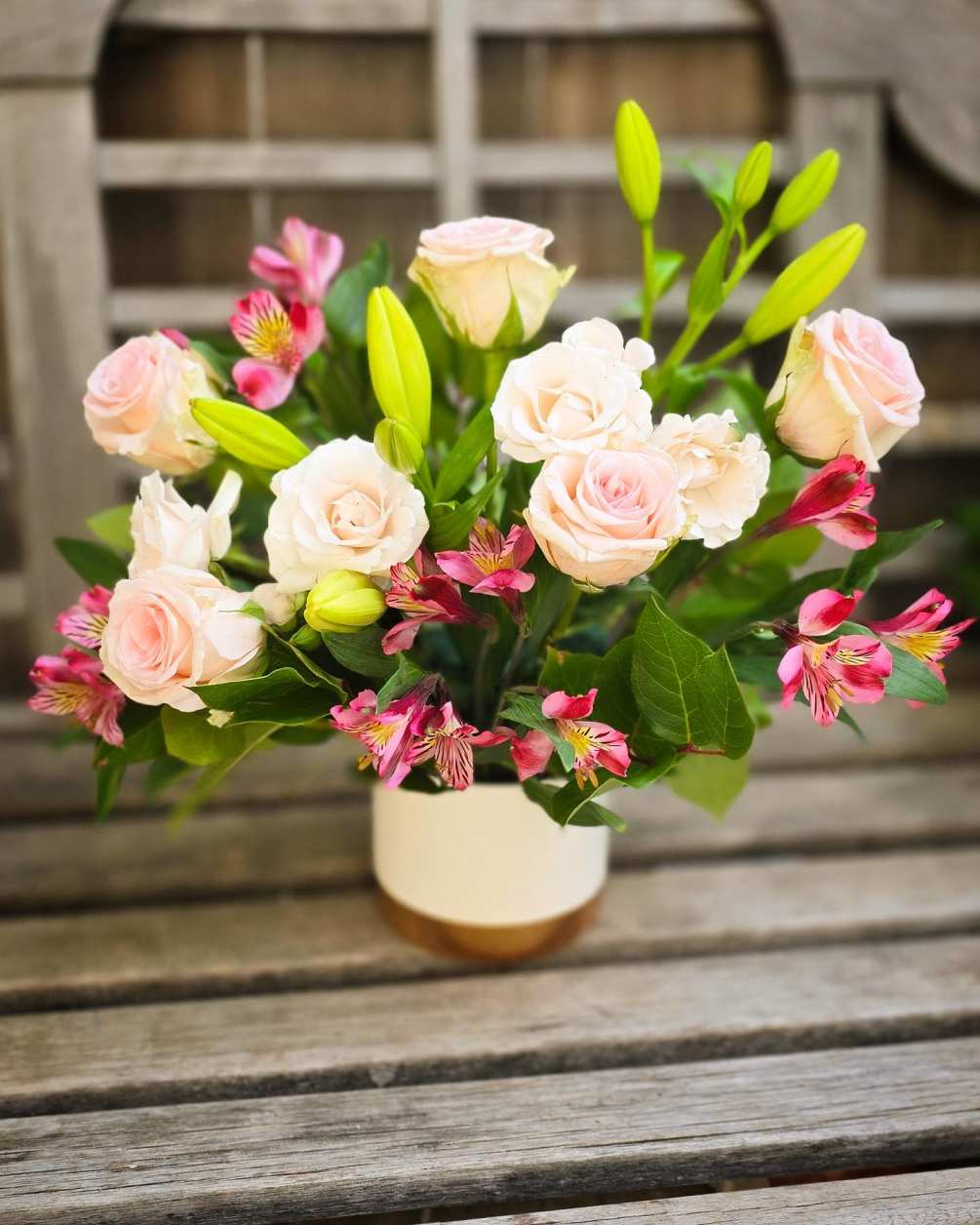 This arrangement is delivered in a white ceramic and features soft pink