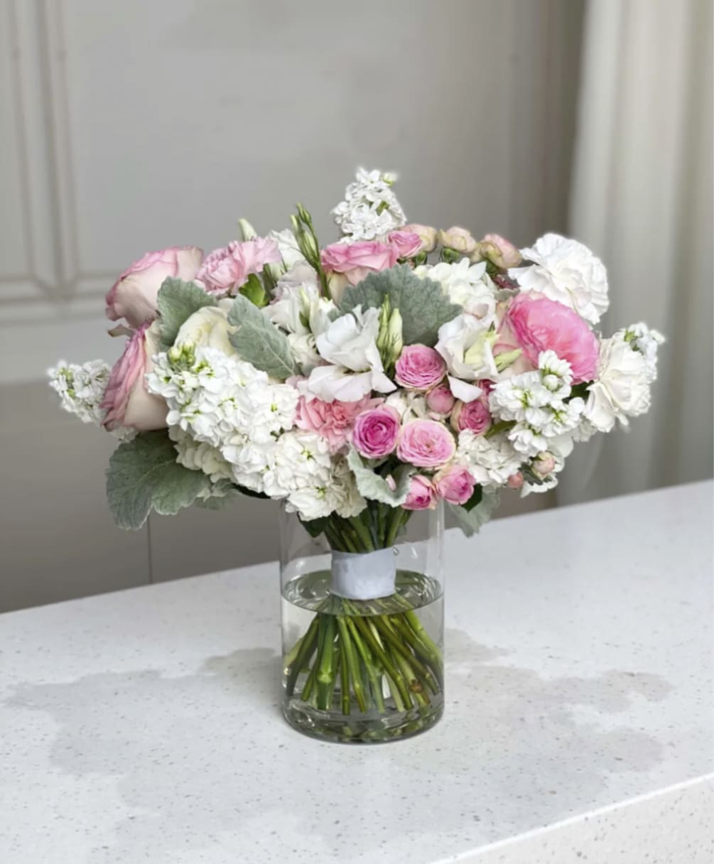 An elegant bouquet with pink roses, white matthiolas  and other flowers