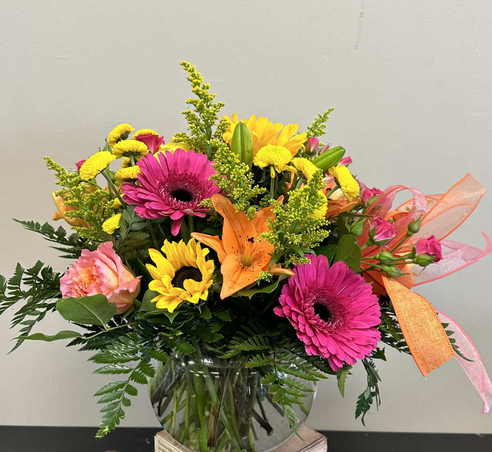 Bright spring florals consisting of sunflowers, orange asiatic lilies, pink gerbera daisies