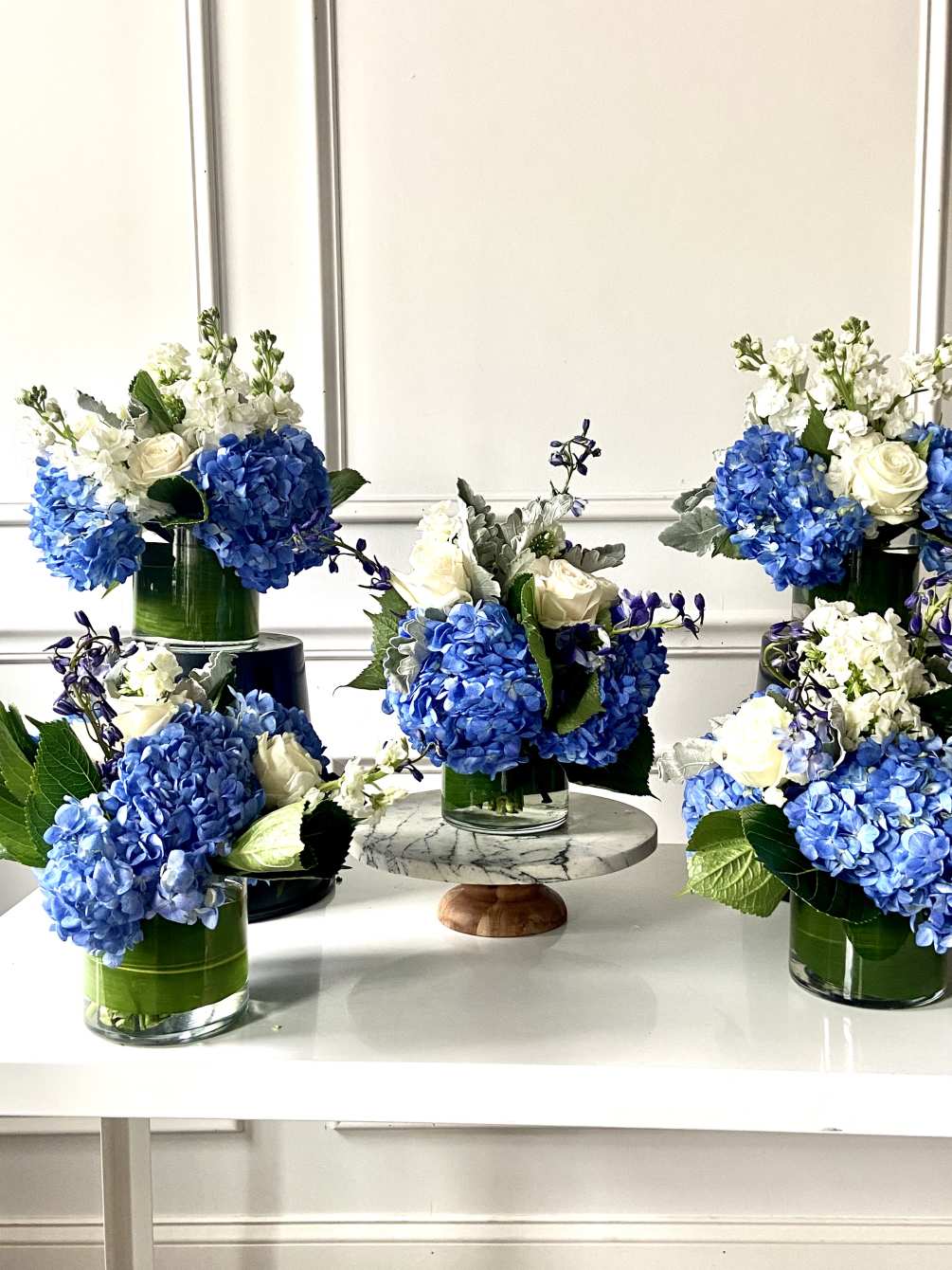 Our Blue Collection showcases shocking blue hydrangea and classic white roses. 
These