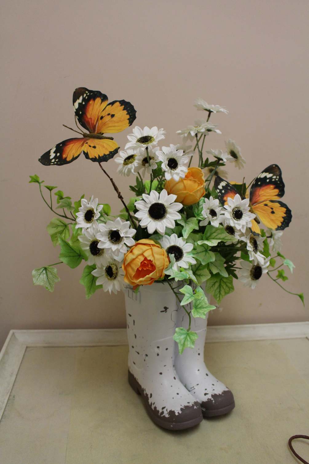 rainboots filled with permanent flowers 
great to take out year after year
