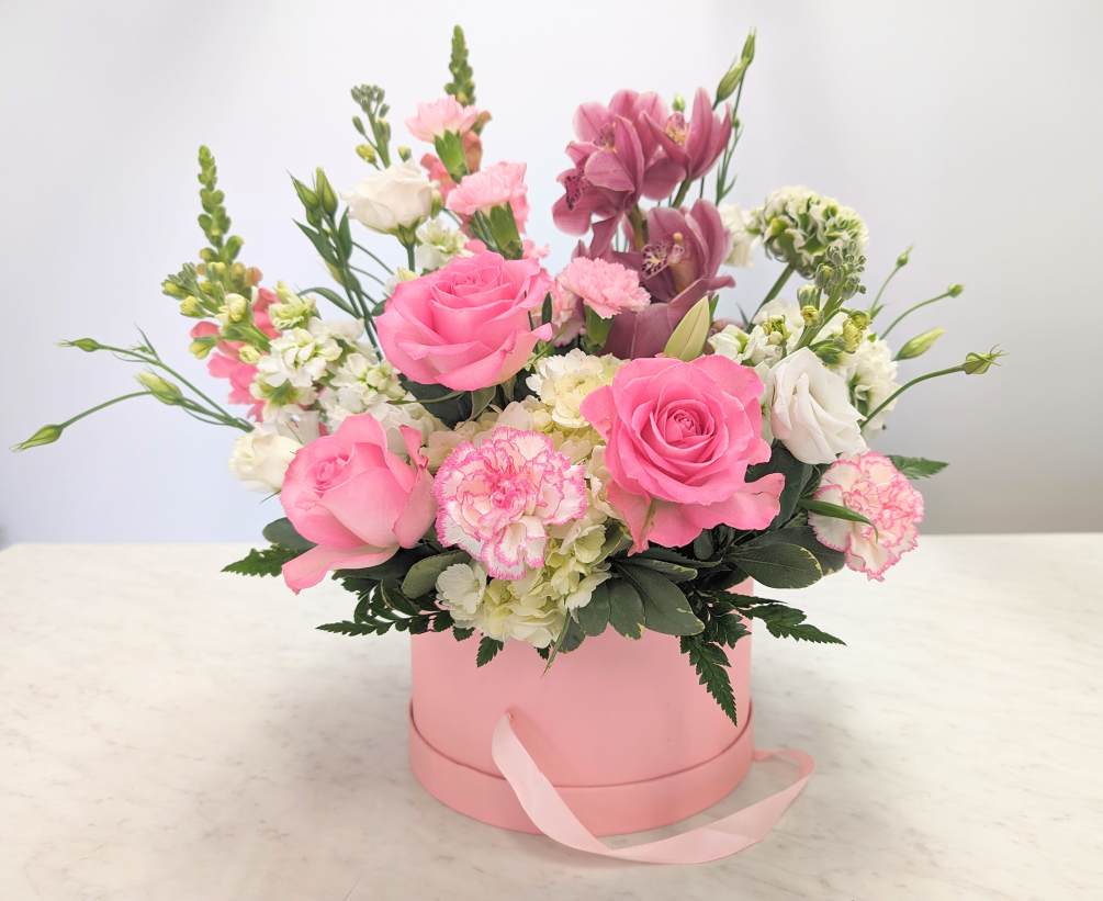 Mix of pink flowers in a hat box