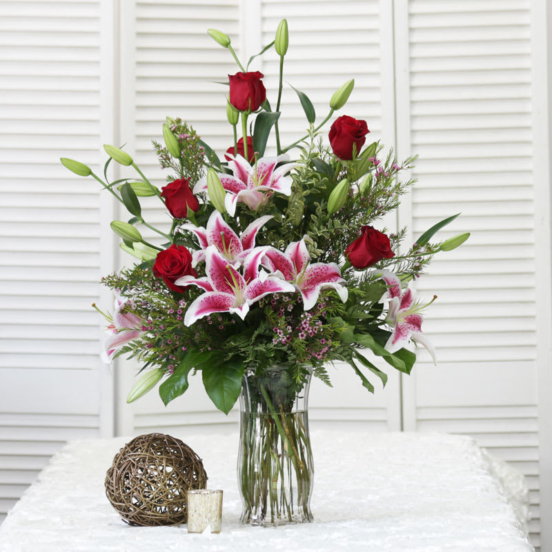 A Romantic Combination of Red Roses and Stargazer Lilies with Pink Wax