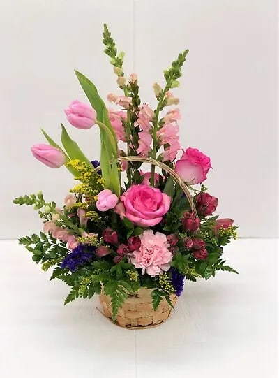 Beautiful basket with tulips, roses and other flowers. This arrangement is perfect