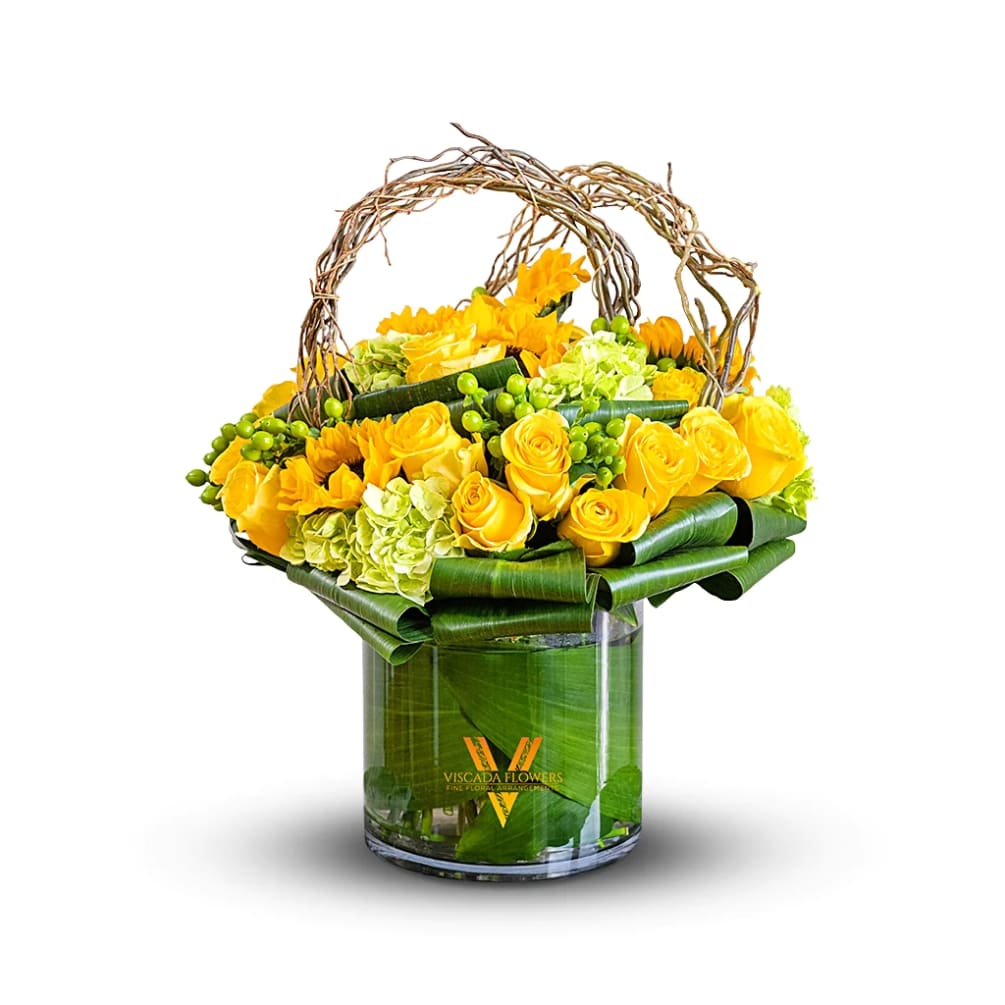 This vibrant bouquet features yellow roses, green hydrangeas, and vibrant florals, creating