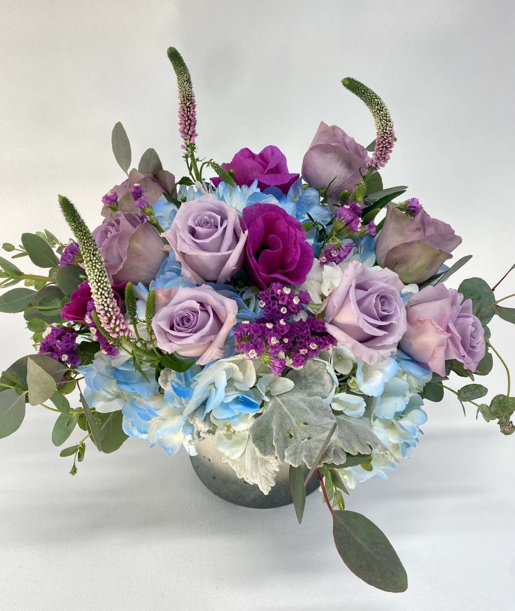 Beautiful blue and purple flower arrangement. Hydrangeas, to tone of purple roses