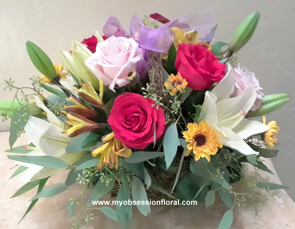 Multi-colored arrangement, low and compact. Fresh floral.
