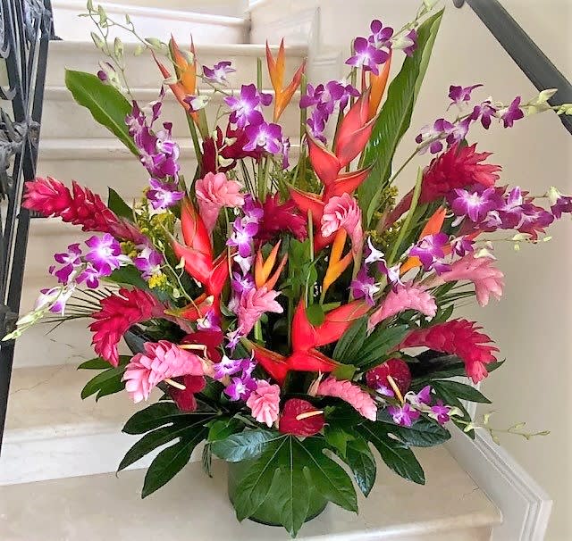 Tropical flowers as shown arranged in a vase