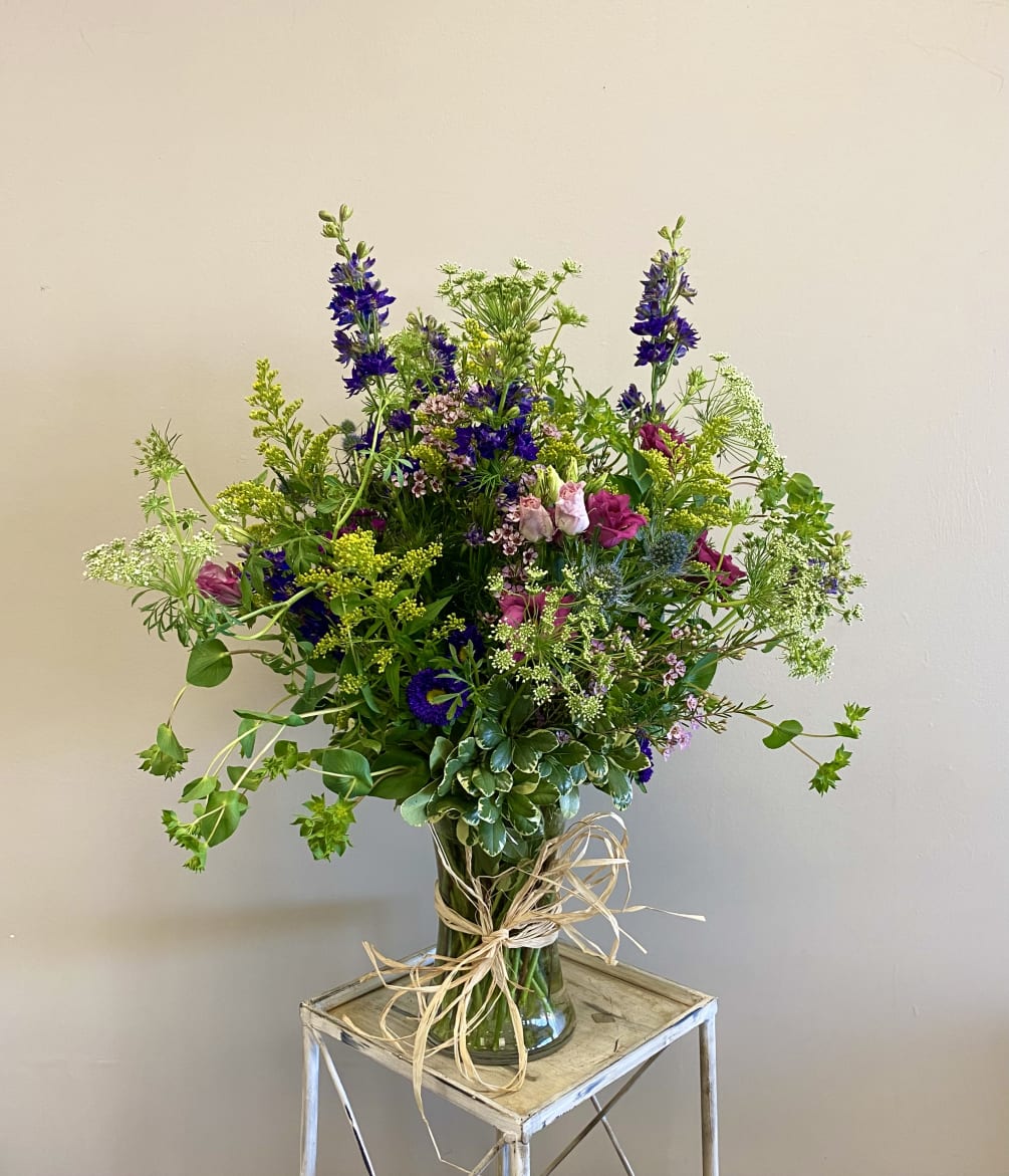 A wildflower style arrangement with free-flowing, organic florals. 