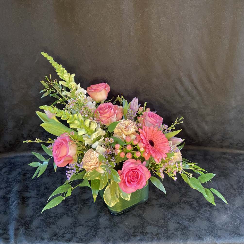 Mixture of pastel colors and flowers in a vase.
