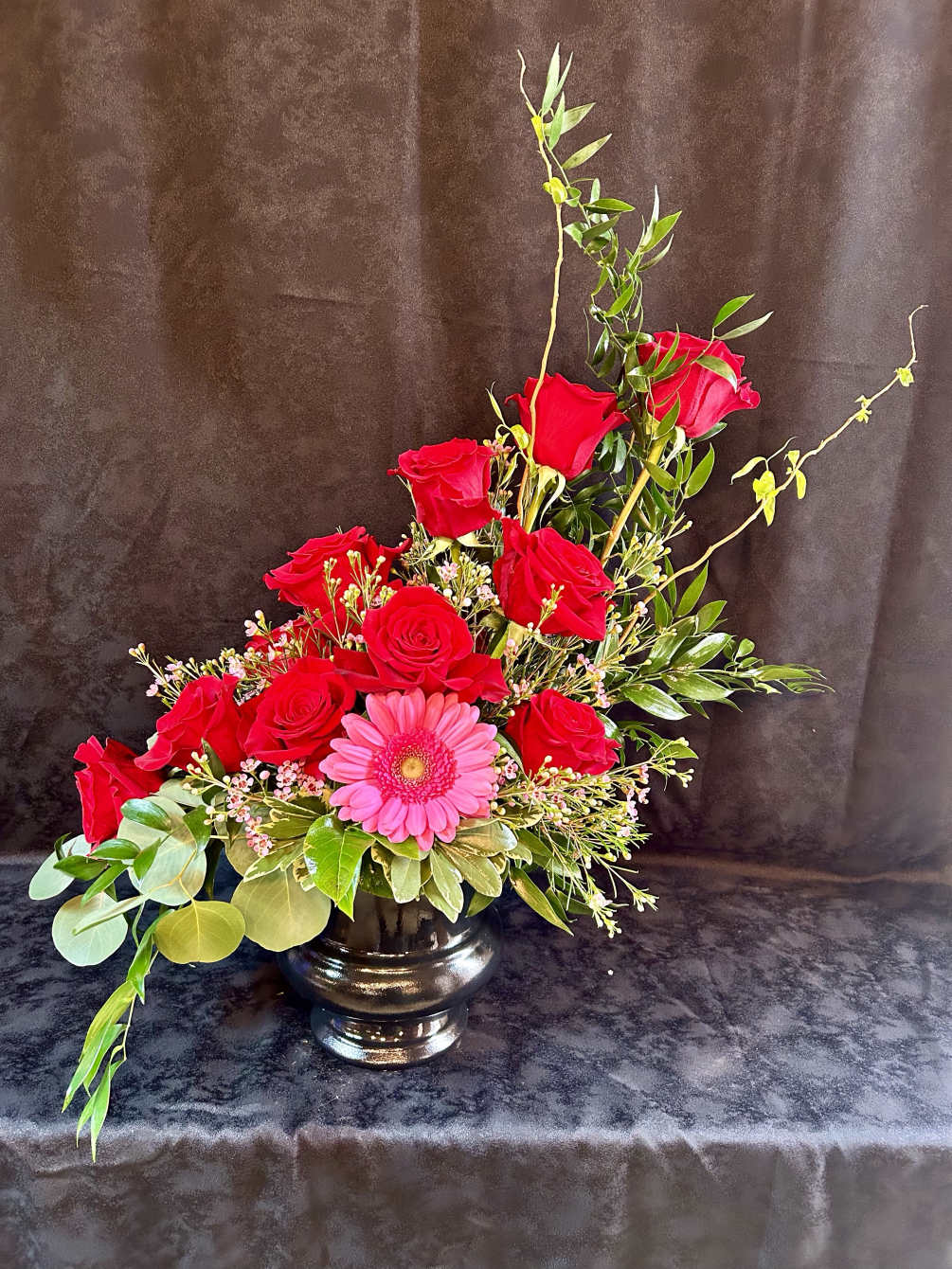 Red roses and pink gerberas designed in a container.