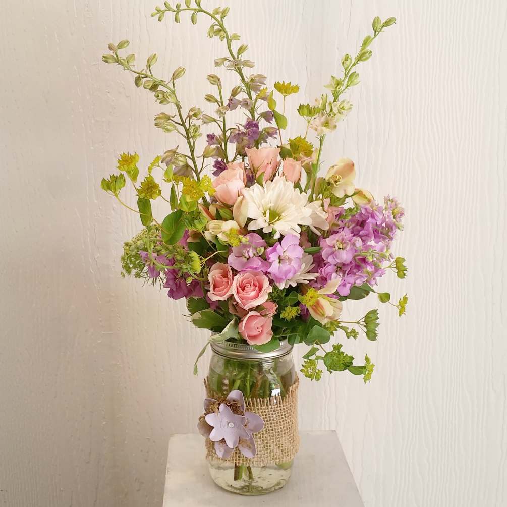 Beautiful spring Mix of larkspur, stock, daisy and spray roses in a