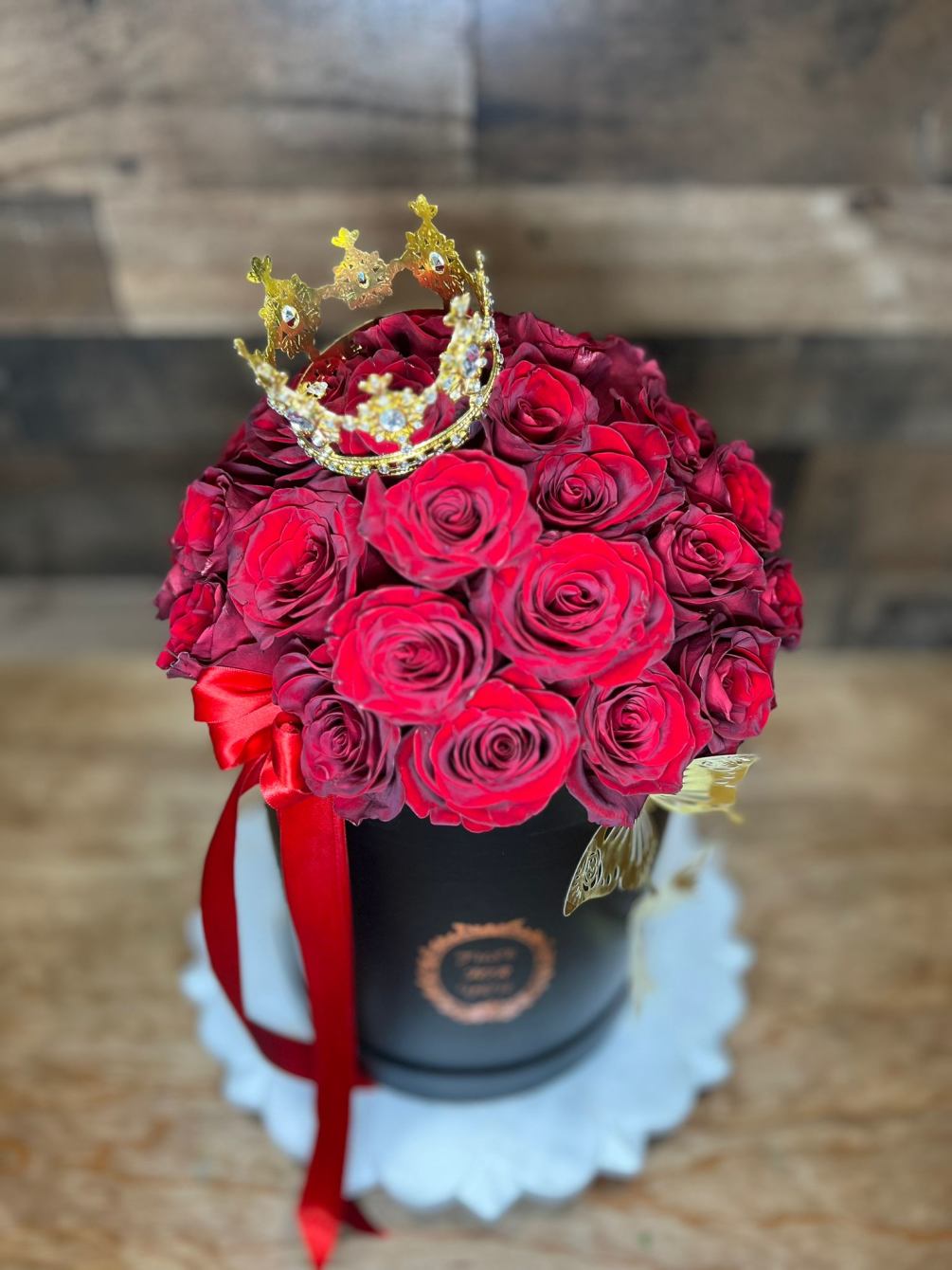 Red roses in a cylinder vase create a classic and elegant floral