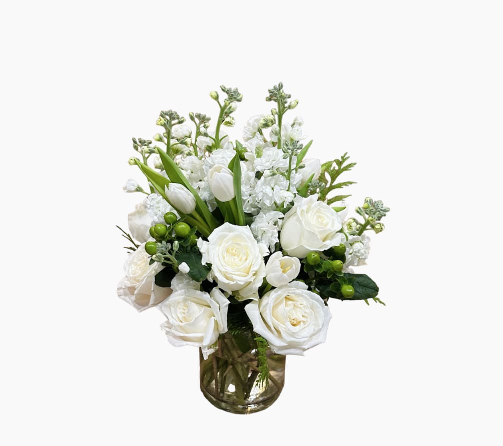 White roses, stocks and white tulips makes this arrangement a perfect piece