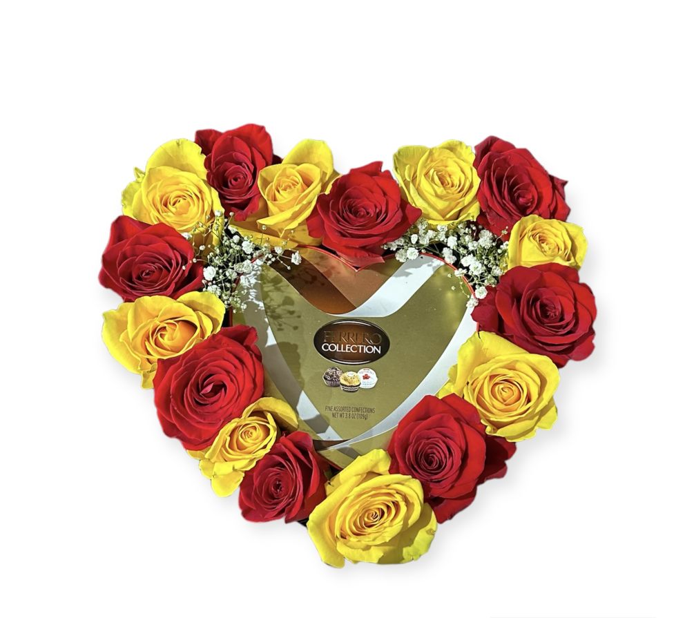 Red and yellow roses with chocolates in a heart shaped box