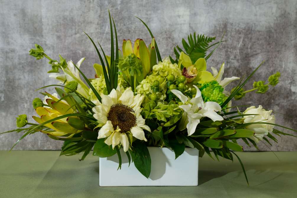 Type of Flowers: Yellow Sunflowers, Bells of Ireland, White Casablanca Lilies, White