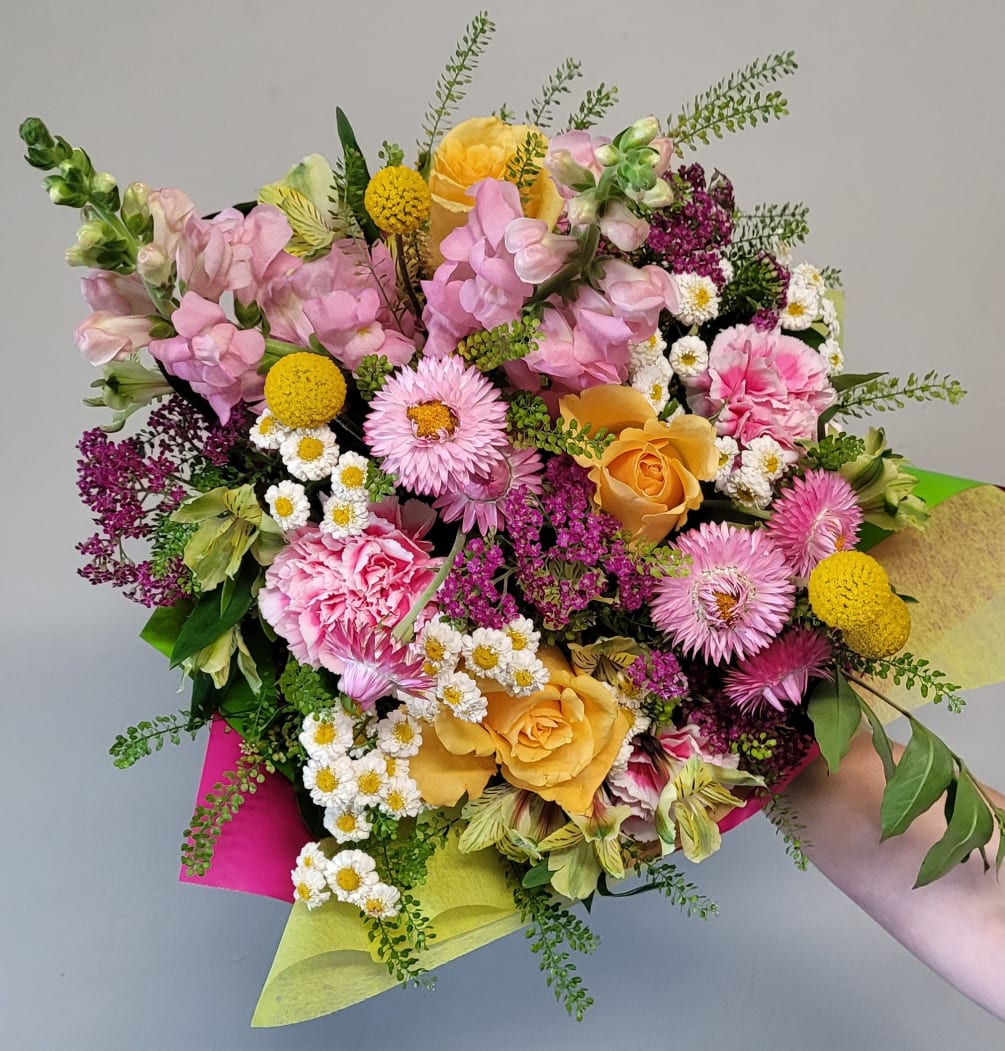 A European-inspired summer Handtied bouquet of summer blossoms, feverfew, Matsumoto Aster, roses