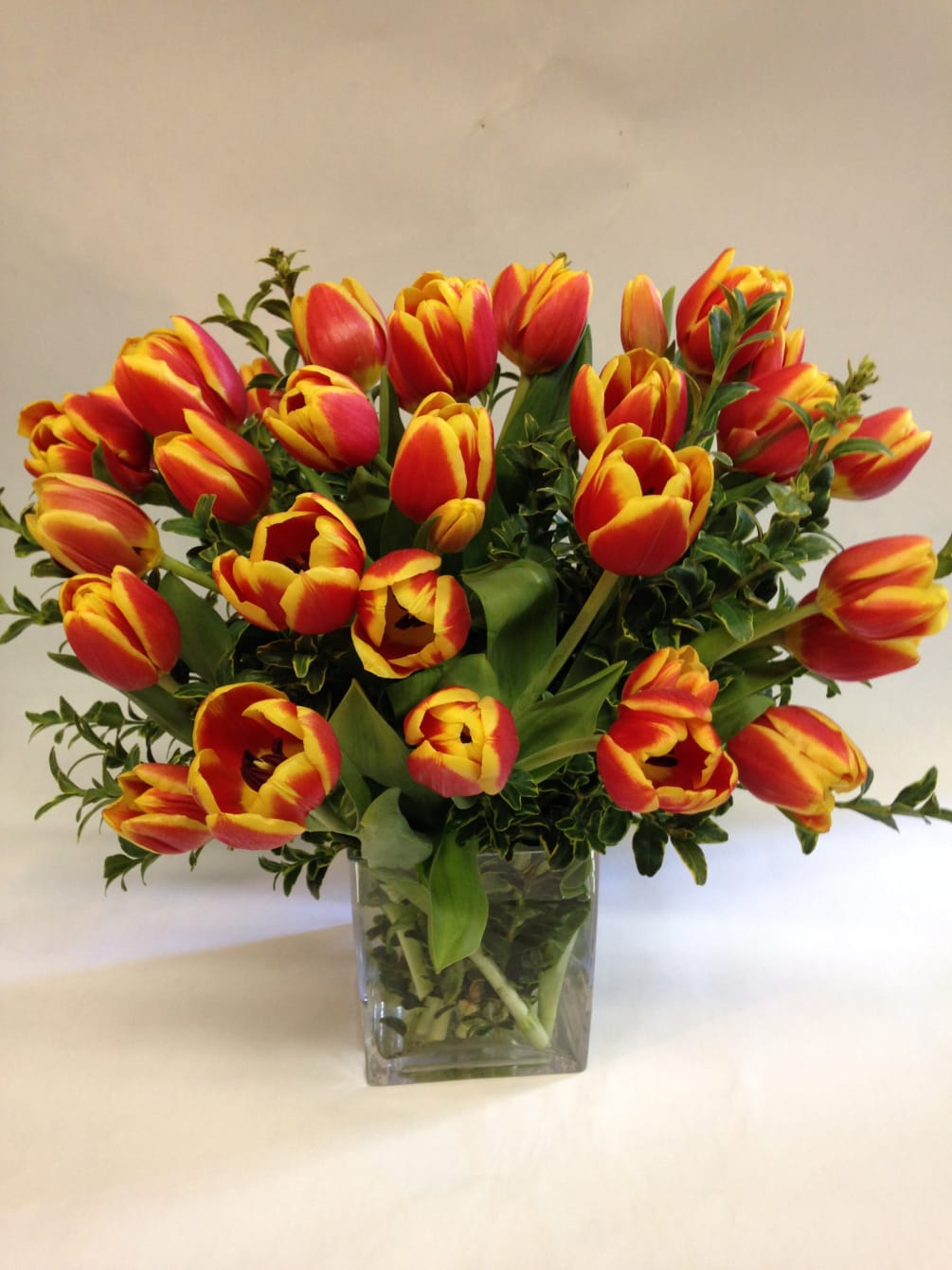 This tulip arrangement can come in a variety of colors: orange, yellow