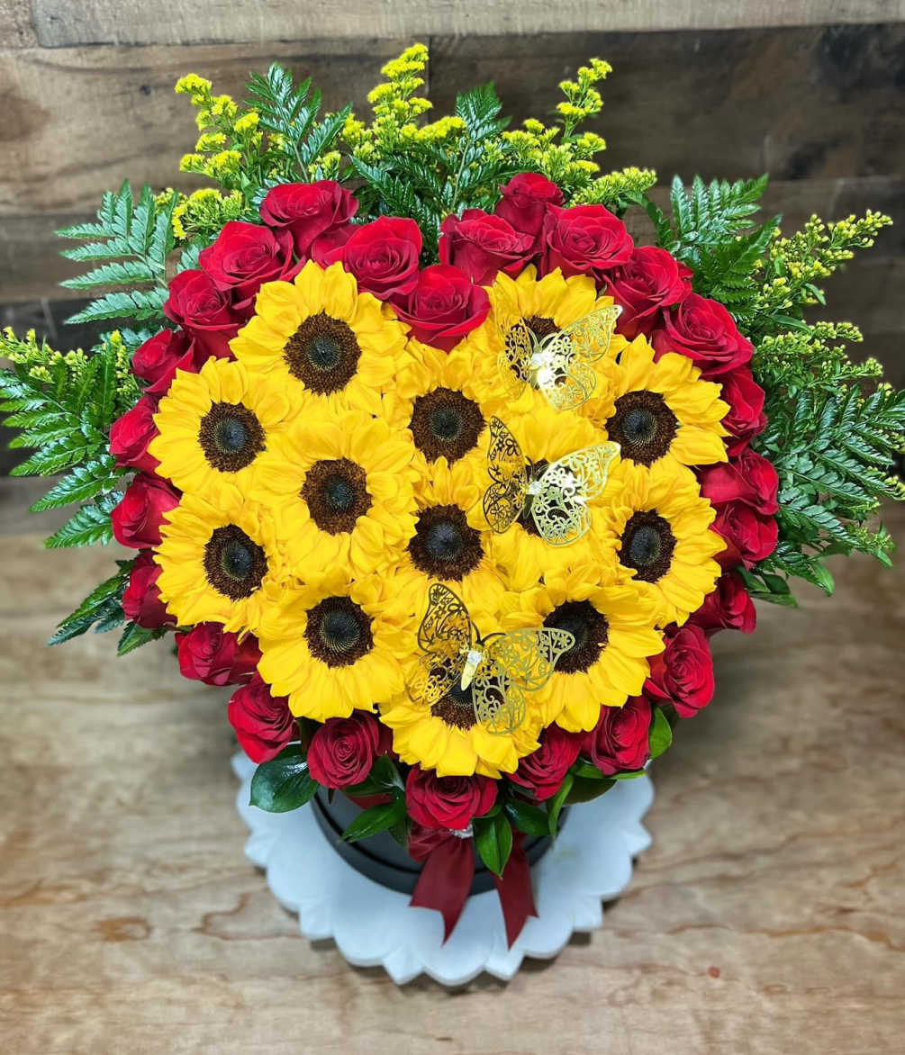 Red roses and sunflowers heart shaped with greenery arrangement is a breathtaking