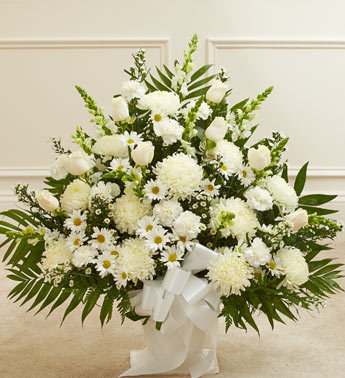 An elegant blend of seasonal mixed flowers in white.  Accented with