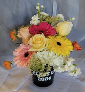 Fresh flowers in a reusable Class of 24 container. Flower arrangement consists