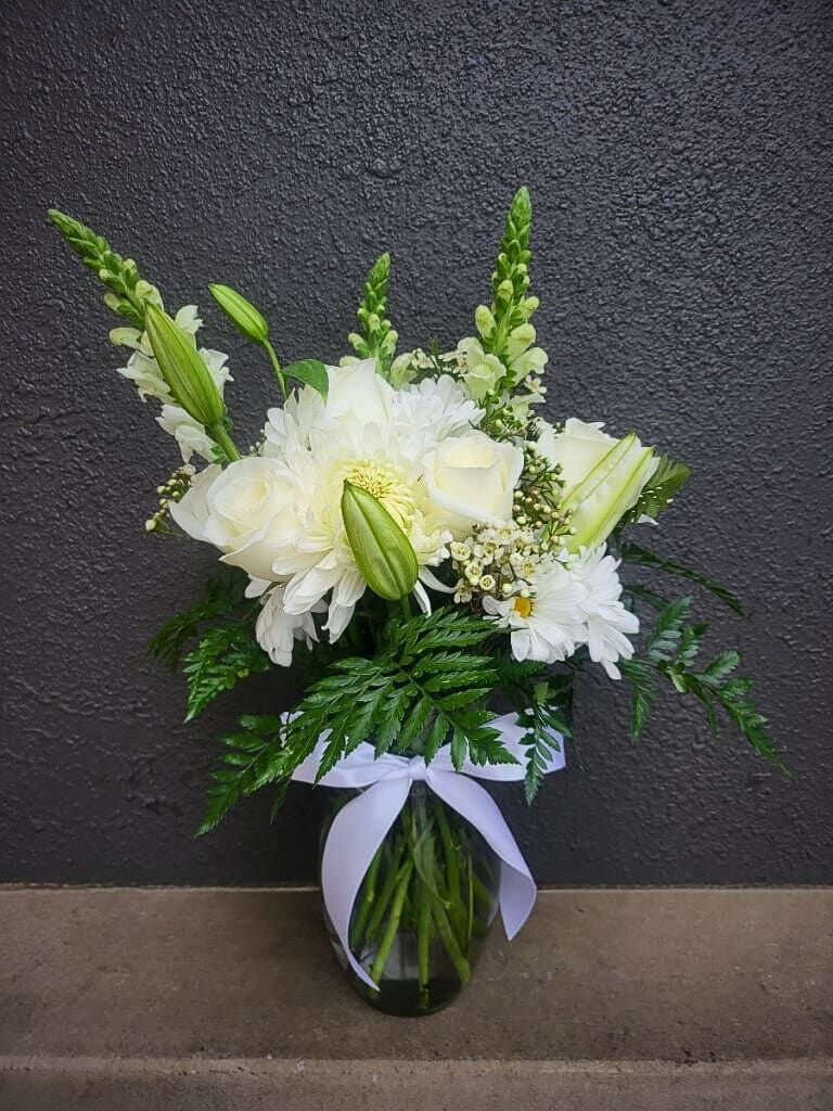 A sympathy arrangement highlighting the pure beauty and delicate nature of life.