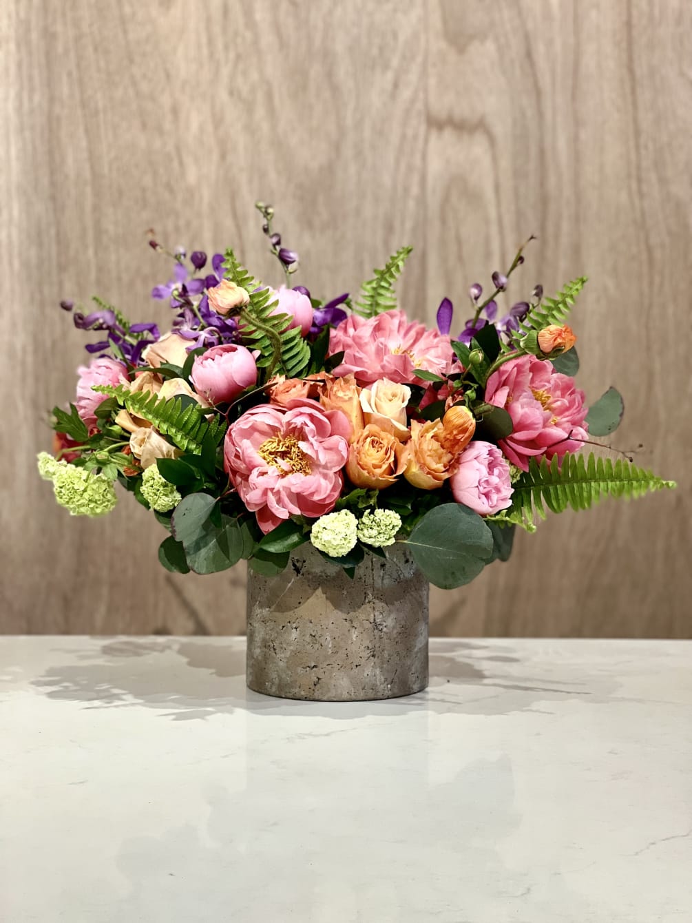 Celebrate the season with our lively display of garden blooms. Abundant coral
