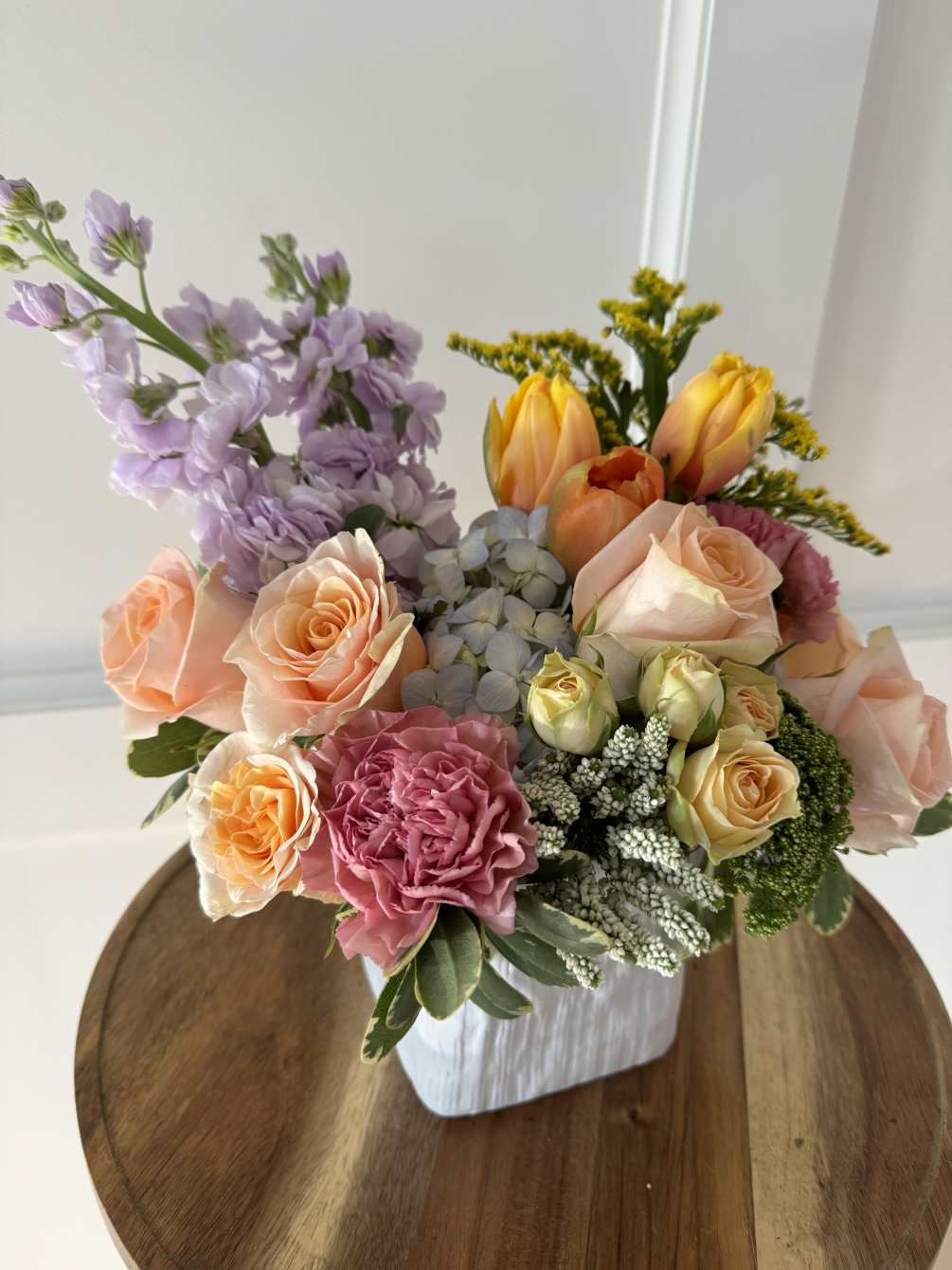 A fresh and colorful arrangement featuring stock, roses, tulips and more.