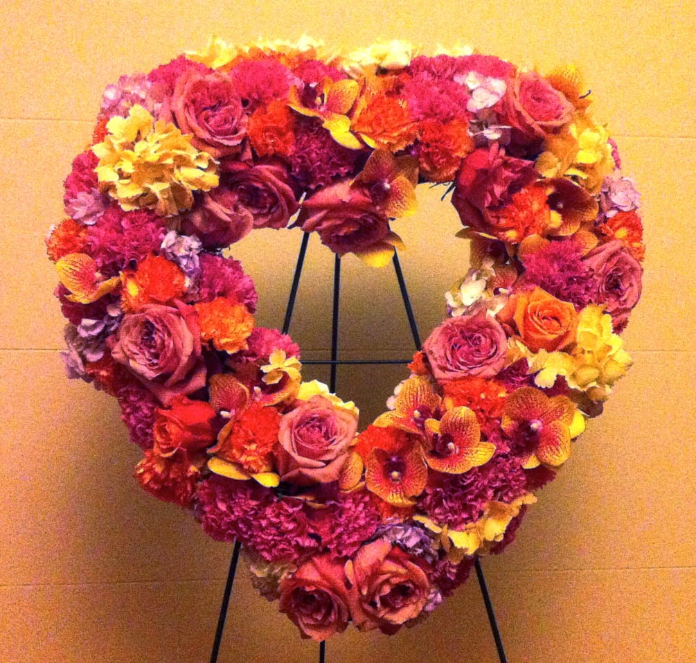 A mix of beautiful fresh blooms in a shape of a heart.