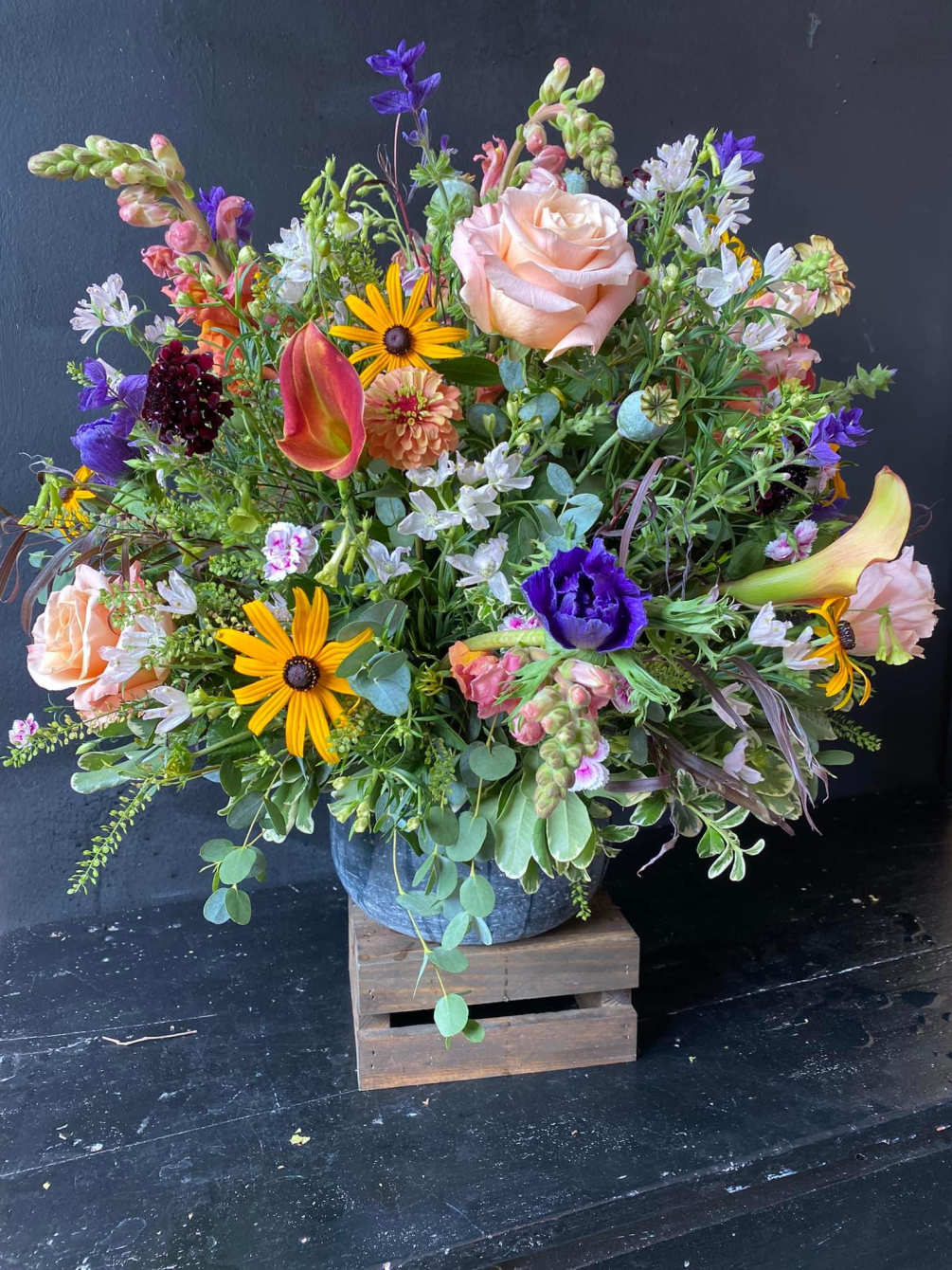 A garden style arrangement with mix local flowers