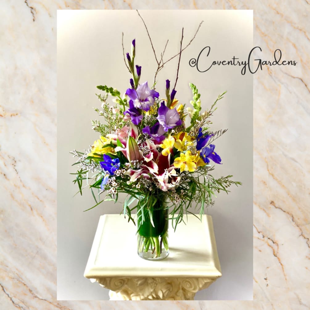 This vase design features the stargazer lily, surrounded by a garden of