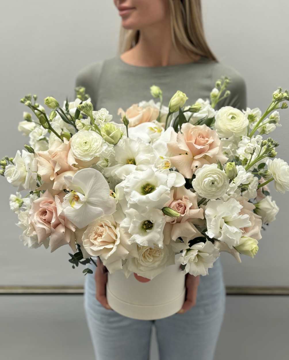 Unforgettable arrangement in a box made with garden roses, phalaenopsis orchid, roses