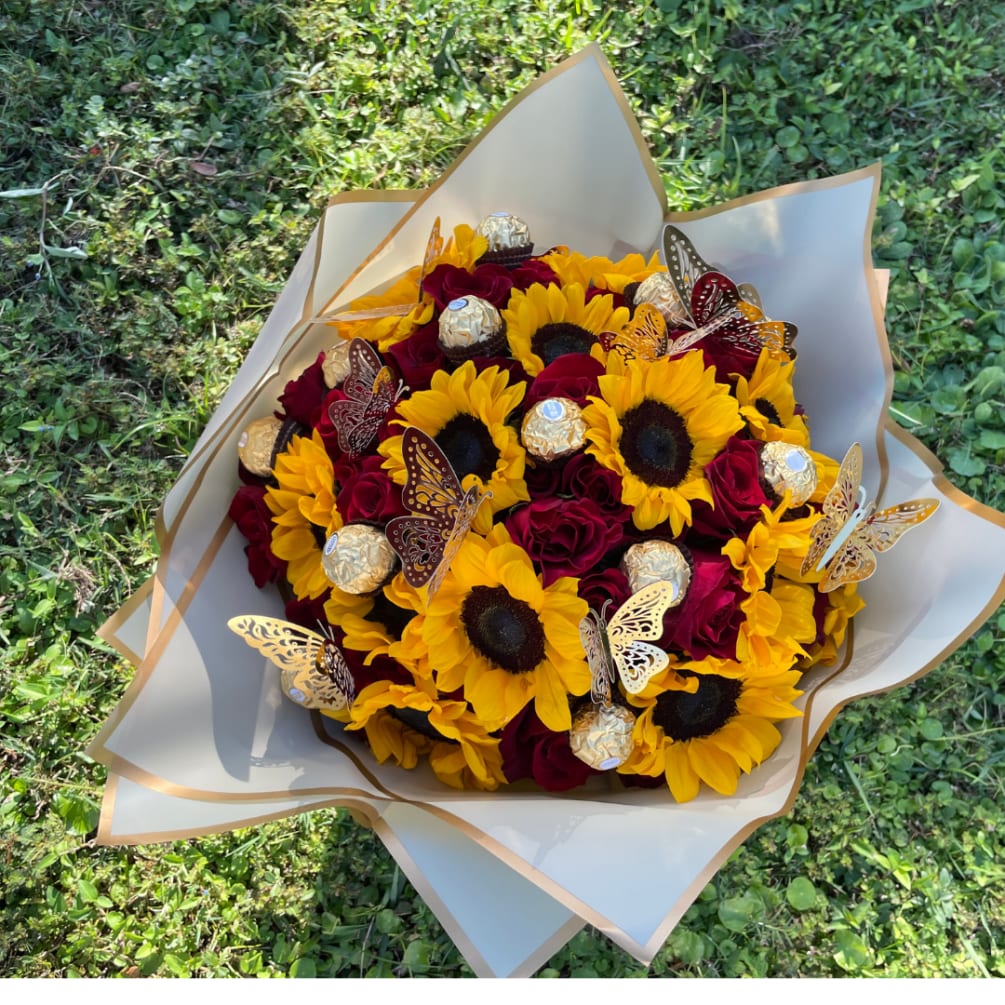 This Luxe Bouquet includes Red roses and Sunflowers, Ferrero Rochers, and Gold