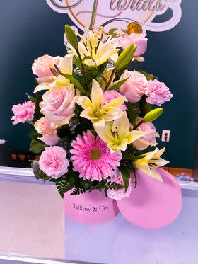 This Elegant design had pink daisies, yellow lilies, and pink carnations. 
