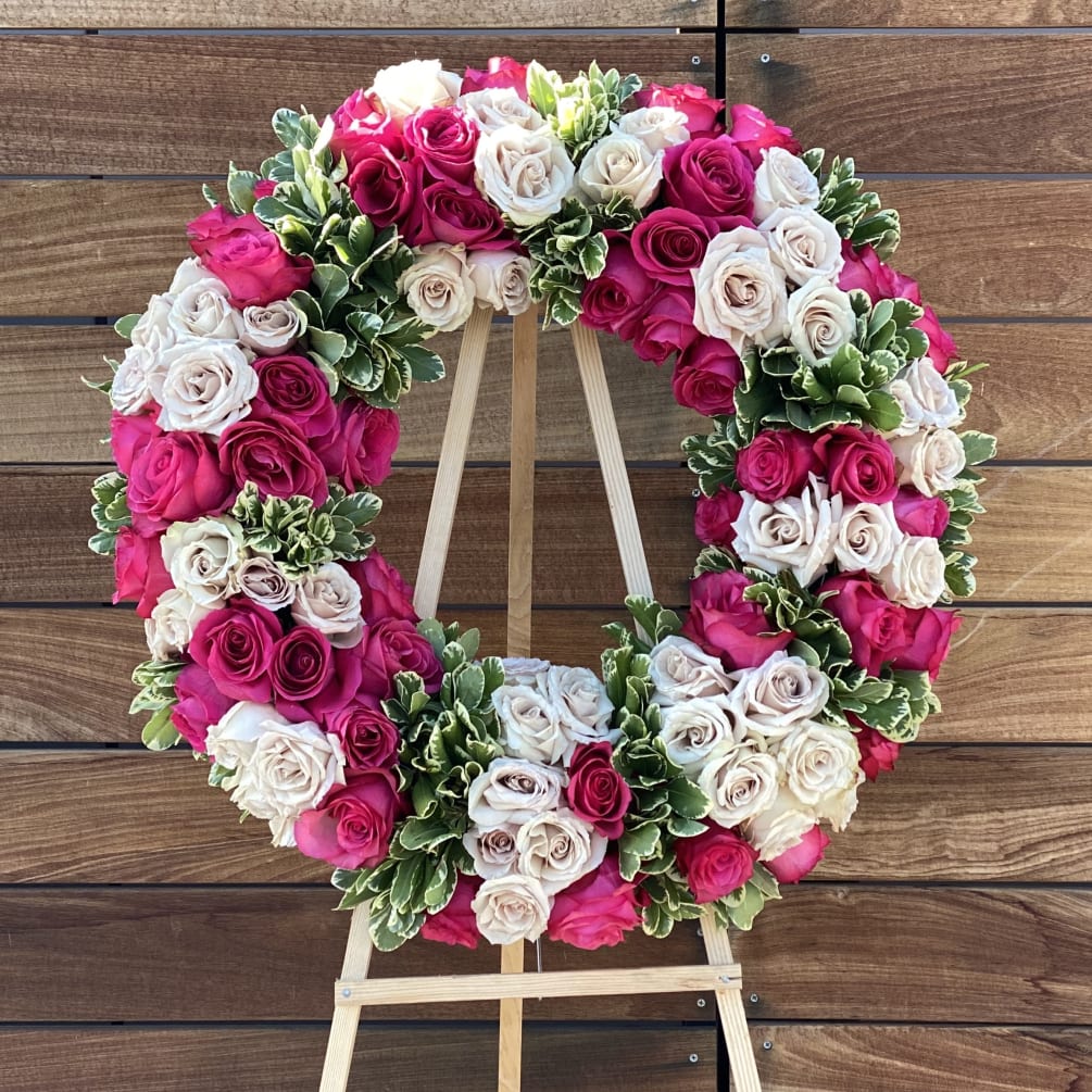 Sympathy arrangement on easel with roses and greenery. (diameter 20 inch)