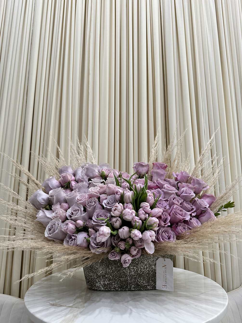his mesmerizing bouquet features a beautiful ombre blend of purple roses and