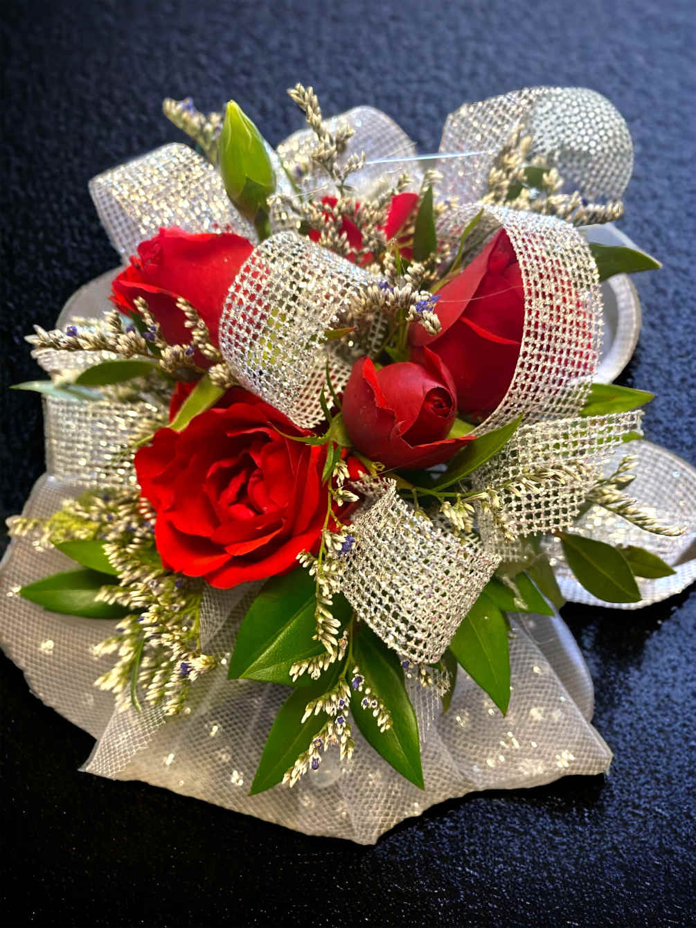 A beautiful, simple, elegant corsage with one complement color of ribbon and
