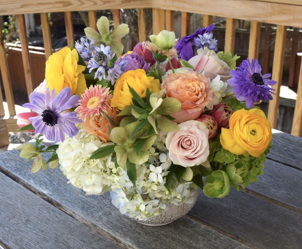 A lovely lush flower arrangement with a rich variety of flowers and