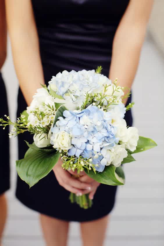This prom bouquet is comprised of Blue Hydrangea, White Hydrangea, White Spray