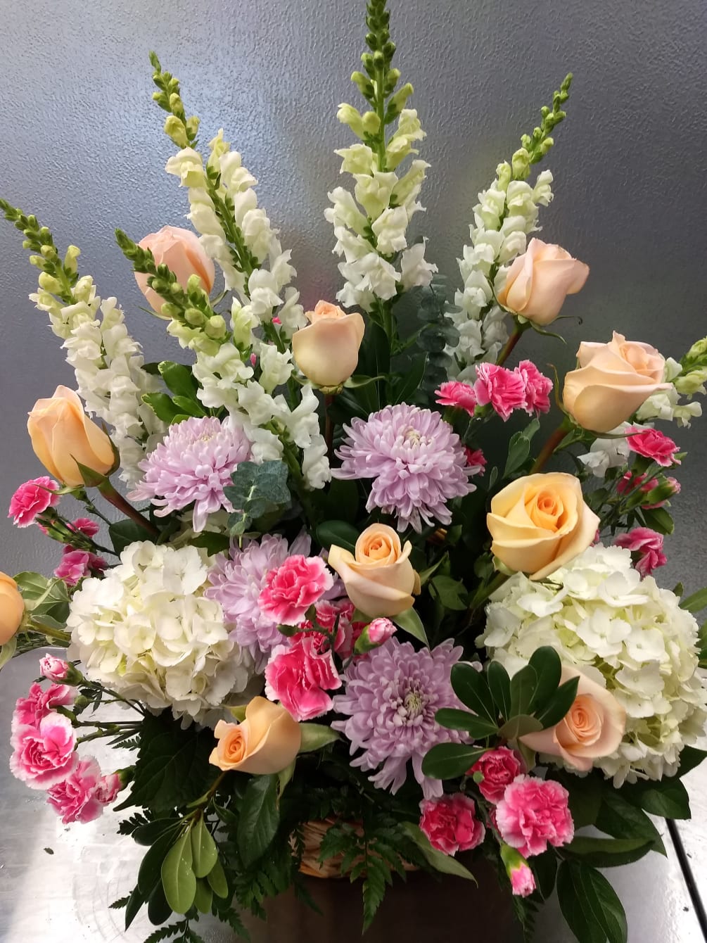 This touching tribute beautifully conveys your sympathy and support. Peach, pink, white