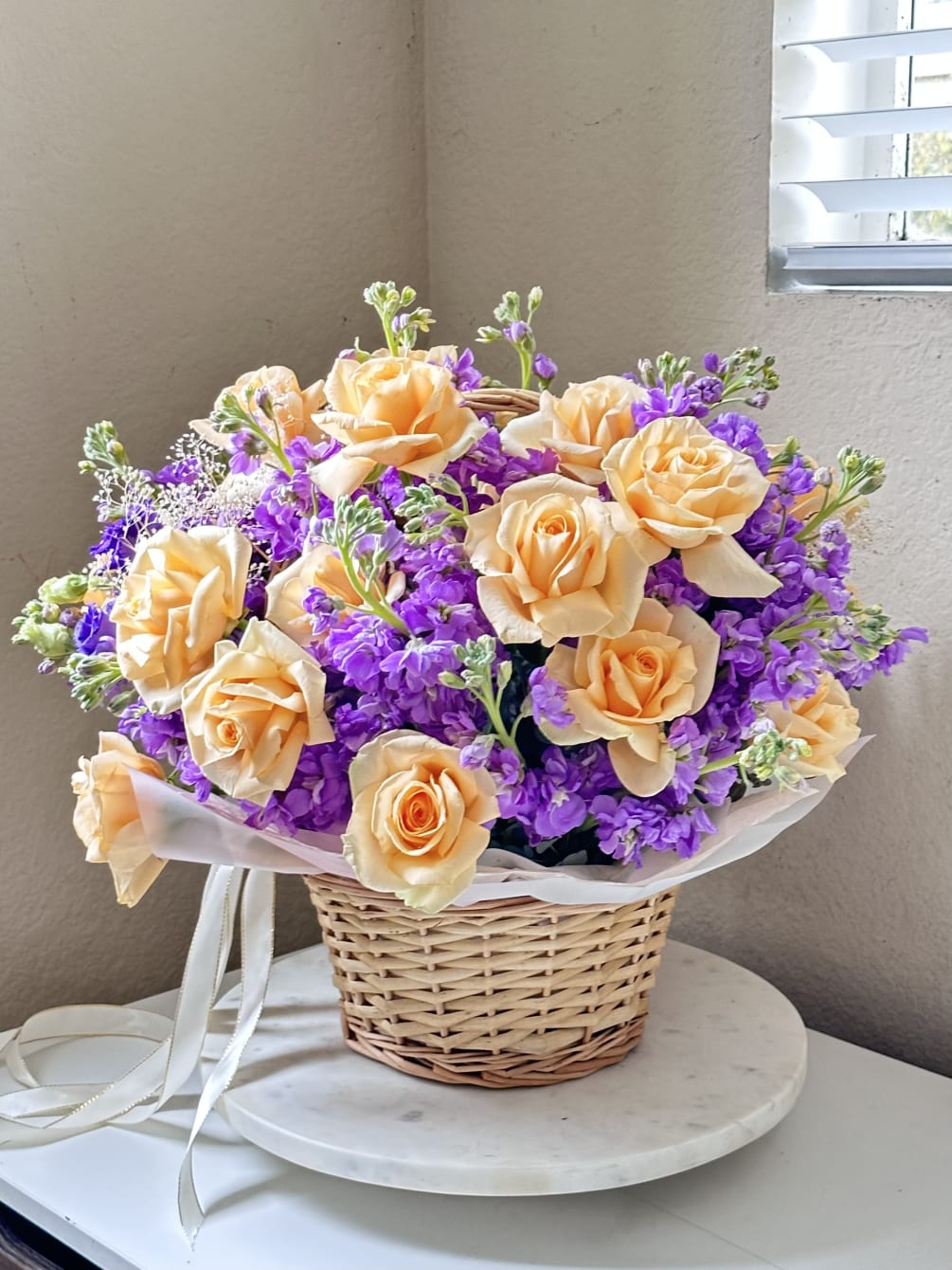  This charming arrangement of fragrant tender matthiolas and delicate peach roses