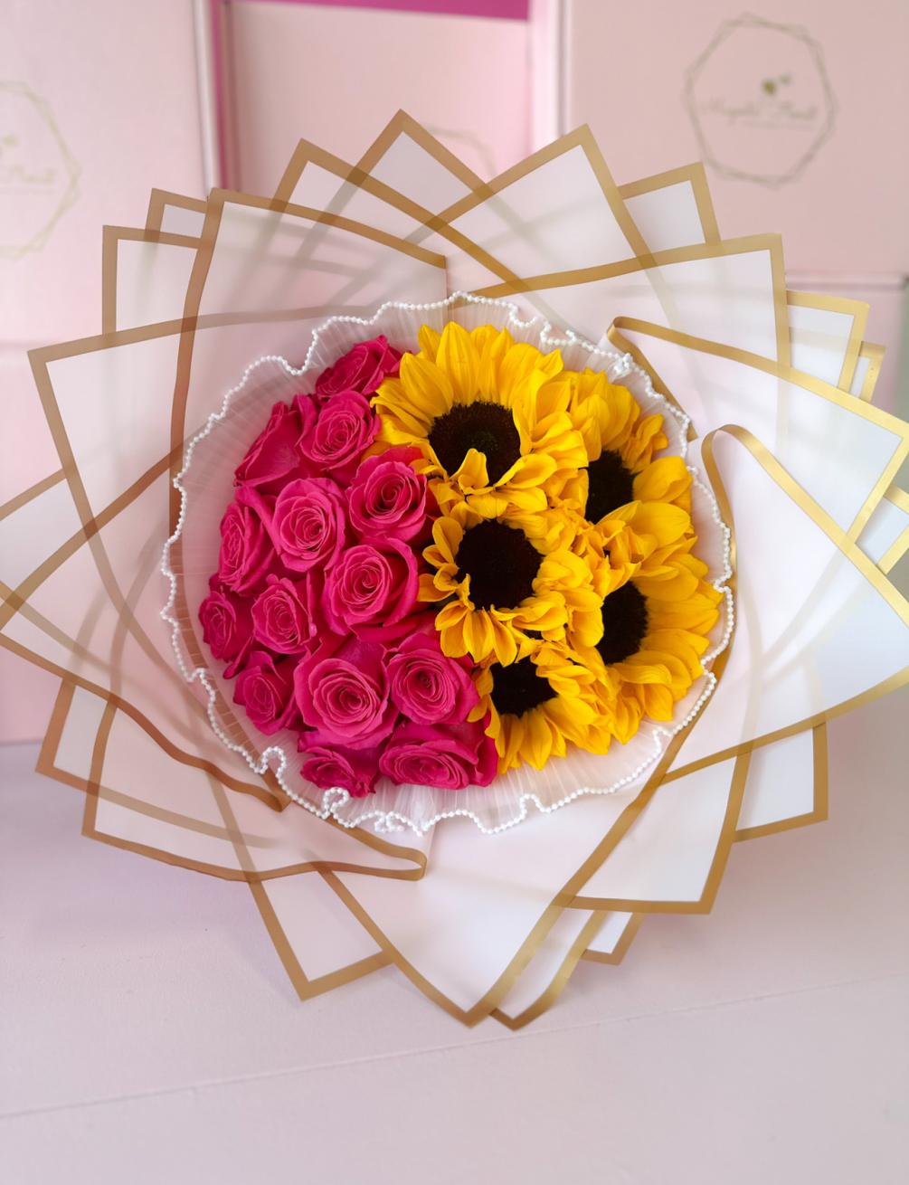 A beautiful bouquet with gorgeous Hot Pink Ecuadorian roses and Sunflowers