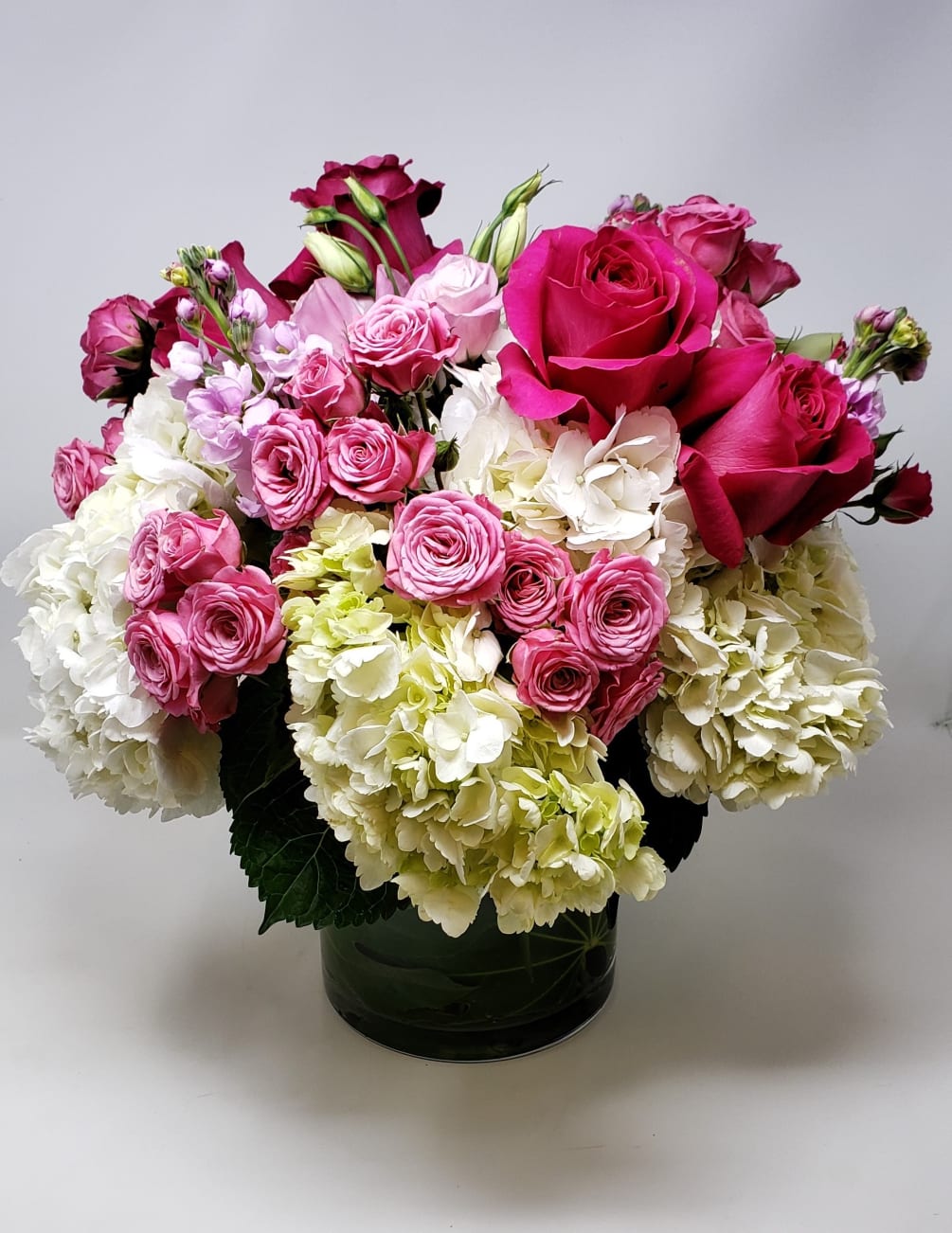 A full lush and pretty feminine bouquet with hydrangeas, roses, fragrant stock
