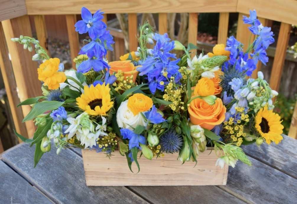 Wonderful seasonal flower box with fresh flowers in a mix of yellow
