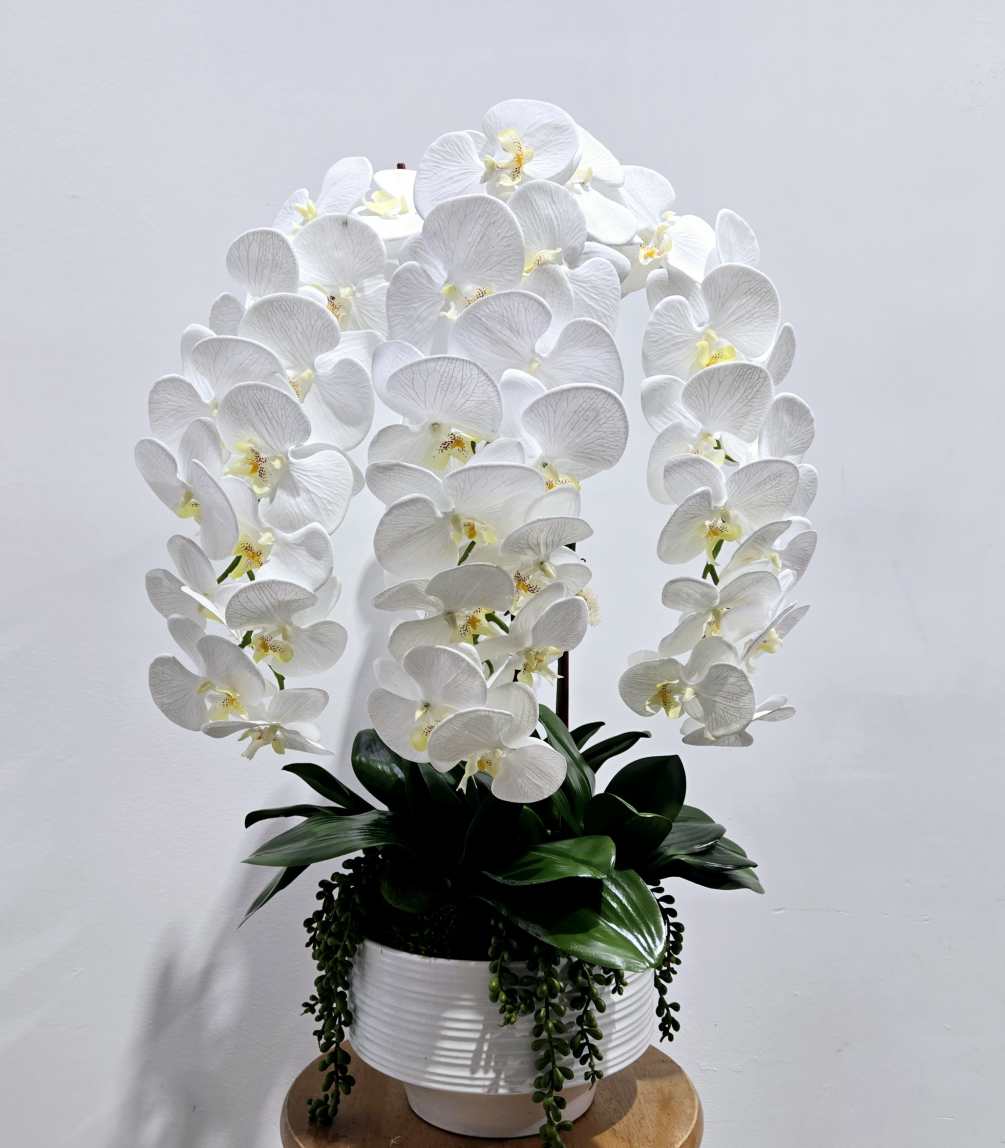 This artificial white phalaenopsis orchid planter is perfect for a home or