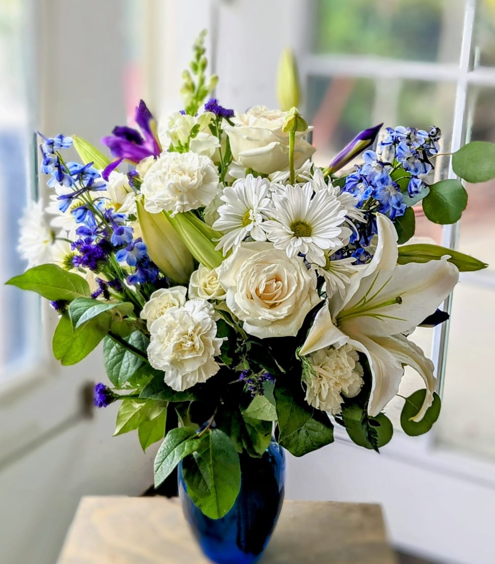 Mixed flower arrangement in a blue vase