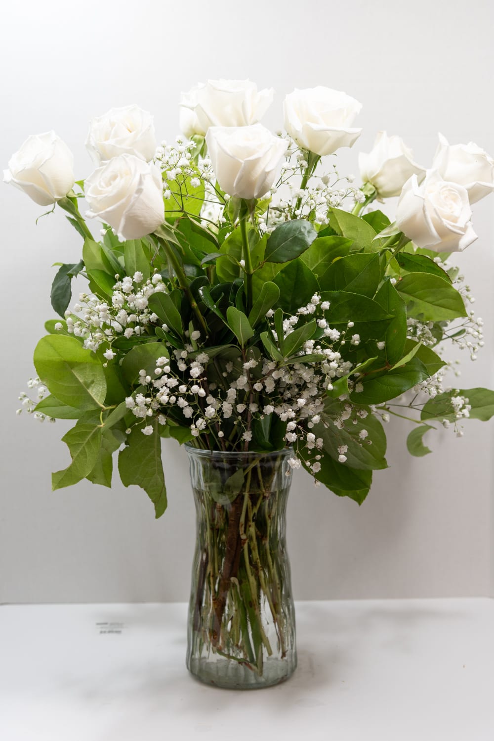 A graceful bouquet of white roses, framed by baby&#039;s-breath filler. The sophisticated