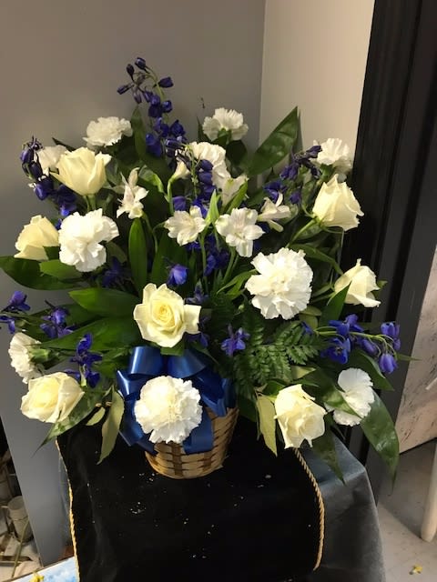 White Roses, Carnations and Alstromeria with Blue Delphiniums in a basket with